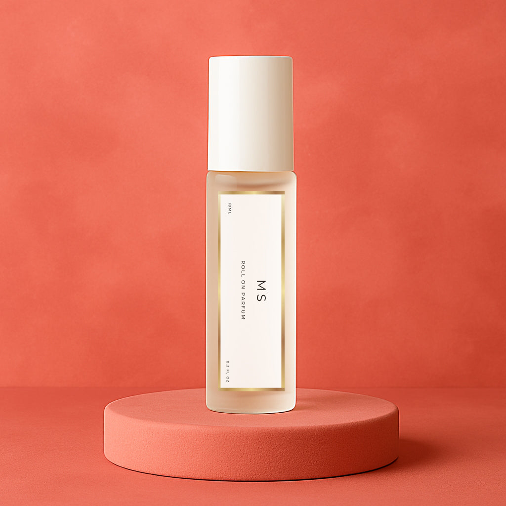 LeScent Ms perfume oil roll-on bottle on a pinkish-red pedestal with a solid pinkish-red background, inspired by Miss Dior.