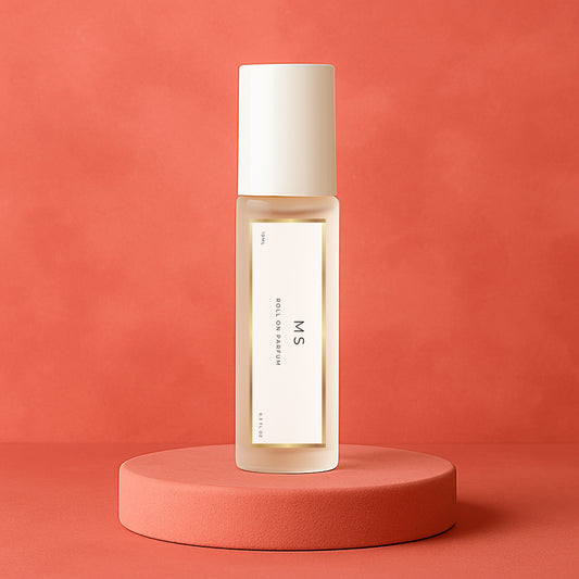 LeScent Ms perfume oil roll-on bottle on a pinkish-red pedestal with a solid pinkish-red background, inspired by Miss Dior.