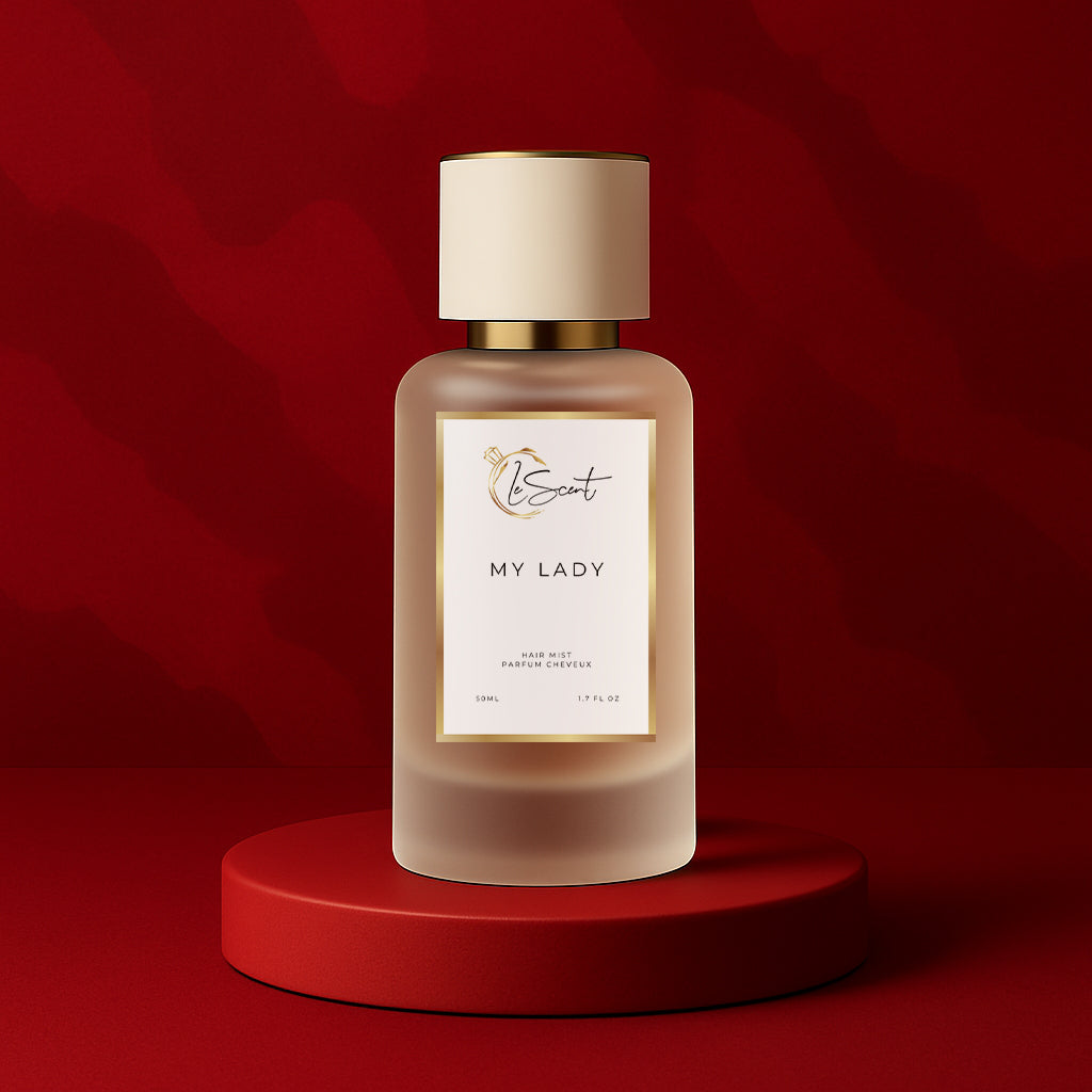LeScent My Lady hair fragrance mist bottle standing on a deep red pedestal with a warm patterned backdrop and soft directional lighting, inspired by Frédéric Malle Portrait of a Lady.
