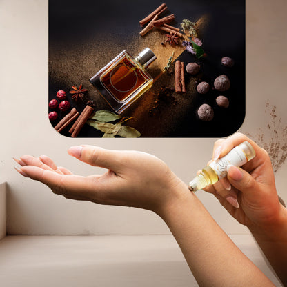 Applying LeScent Naughty Boys perfume oil roll-on inspired by Carolina Herrera Bad Boy — warm tonka bean and spicy pepper notes for a long-lasting and confident feeling.