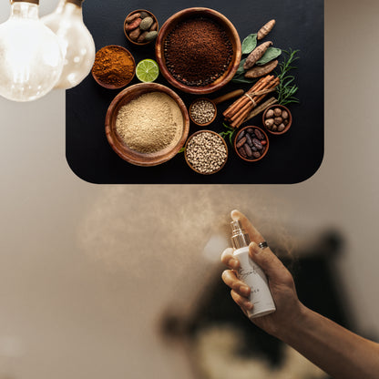 Spraying LeScent Naughty Boys room spray inspired by Carolina Herrera Bad Boy — warm spicy and gourmand home fragrance freshener mist with cacao, cinnamon, and ginger accords.