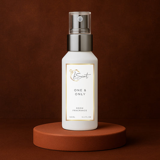 LeScent One & Only room fragrance spray bottle displayed on a dark terracotta platform with deep brown background and golden accent lighting, inspired by Dolce & Gabbana The One.