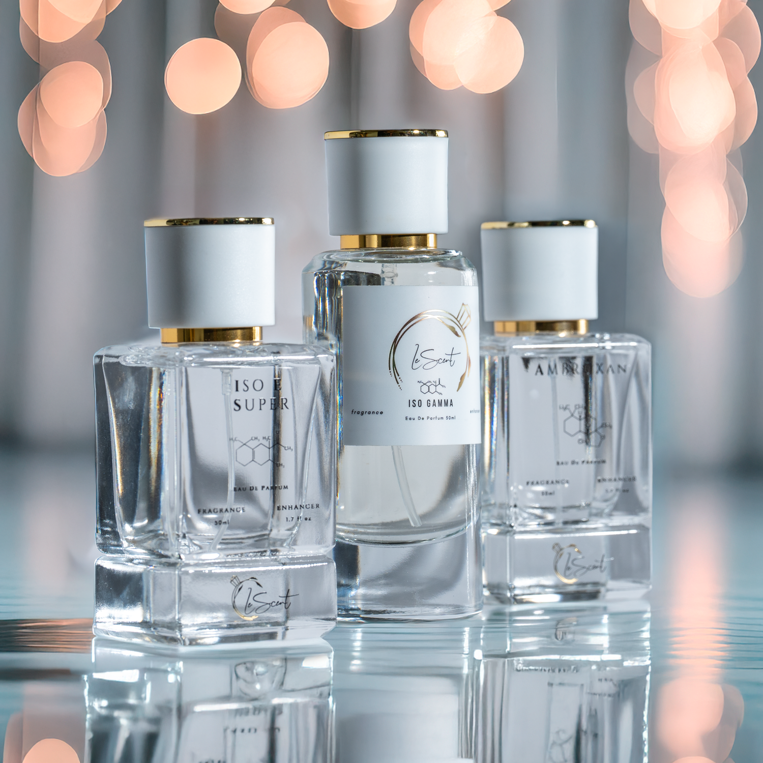 A group product photo of the LeScent fragrance enhancer and perfume primer collection, featuring ISO E SUPER, ISO GAMMA, and AMBROXAN bottles.