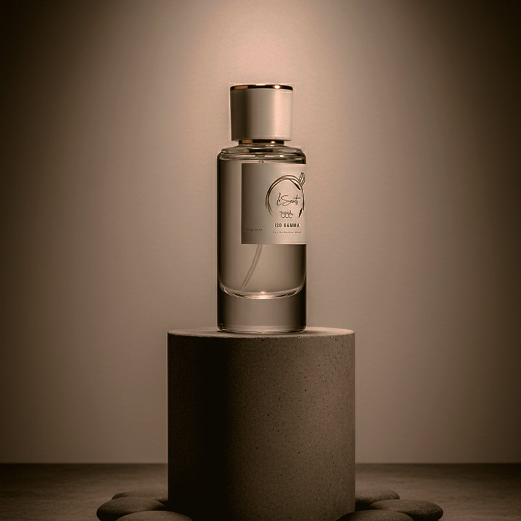 LeScent Iso Gamma perfume primer bottle displayed on a stone pedestal in a minimal studio setting.