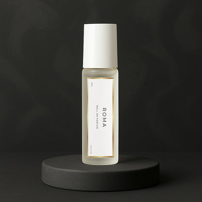 LeScent Roma roll-on perfume oil bottle standing on a matte charcoal platform with soft lighting and dark background, inspired by Valentino Uomo Born In Roma.
