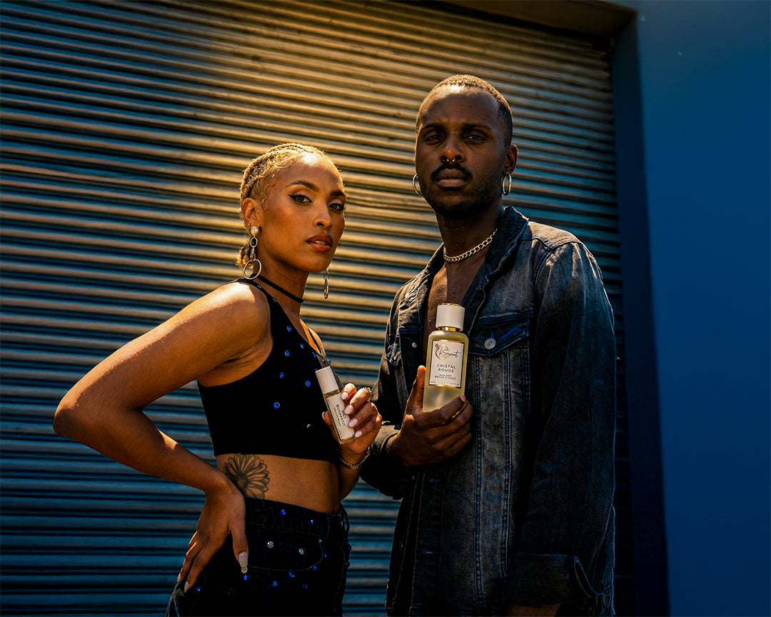 Two models holding LeScent Sapphire hair mist and roll-on perfume oil, hair perfume, hair fragrance, hair perfume mist, and parfum oil roller.