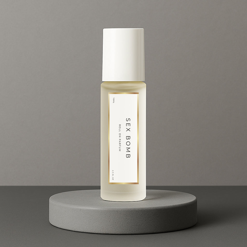 LeScent Sex Bomb perfume oil roll-on bottle on a grey concrete pedestal with a solid grey background, inspired by Viktor & Rolf Spicebomb.