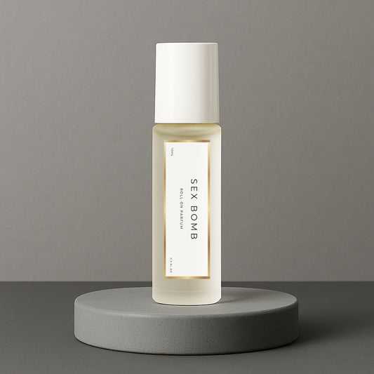LeScent Sex Bomb perfume oil roll-on bottle on a grey concrete pedestal with a solid grey background, inspired by Viktor & Rolf Spicebomb.