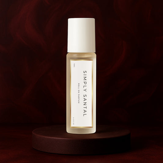 LeScent Simply Santal roll-on perfume oil bottle standing on a dark mahogany platform against a deep burgundy background with soft studio lighting, inspired by Le Labo Santal 33.