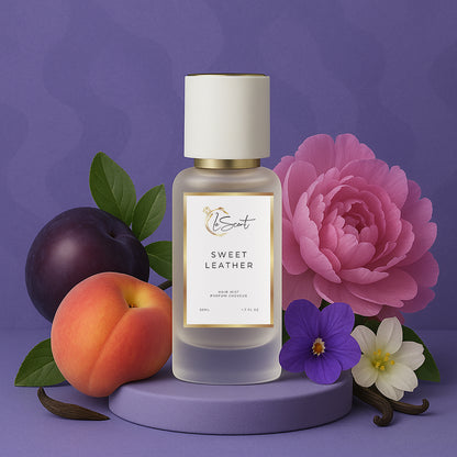 LeScent Sweet Leather hair perfume mist bottle surrounded by ripe peaches, dark plums, pink peonies and white blossoms on a lavender platform, inspired by Byredo Bibliothèque.