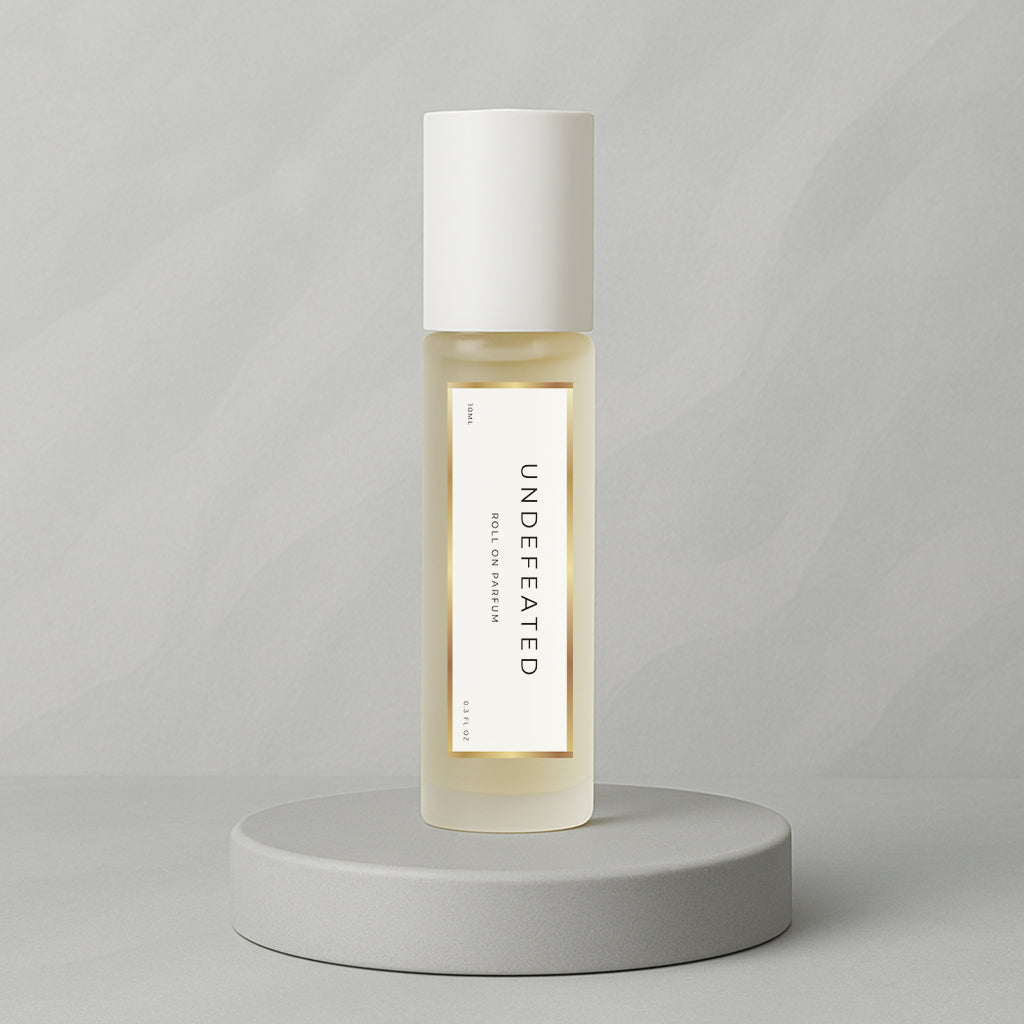 LeScent Undefeated roll-on perfume oil and parfum oil roller bottle on a soft grey background, luxury long lasting perfume oil inspired by Paco Rabanne Invictus.