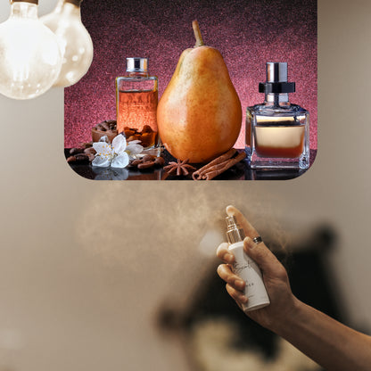 Spraying LeScent Vanille Café home fragrance freshener mist beside pear, vanilla, star anise, and cinnamon on a warm amber surface, inspired by Yves Saint Laurent Black Opium.