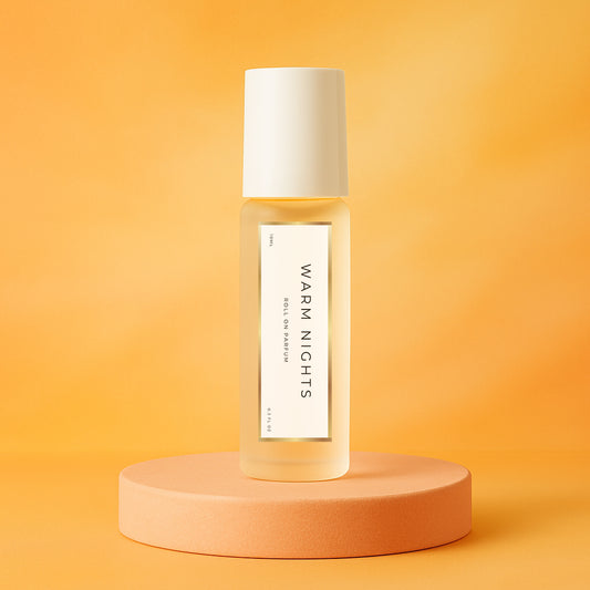 LeScent Warm Nights perfume oil roll-on bottle on an orange pedestal with a solid orange background, inspired by Maison Margiela By The Fireplace.