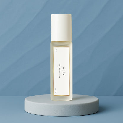 LeScent Why roll-on perfume oil bottle placed on a cool blue platform with soft matte background and clean lighting, inspired by YSL Y.